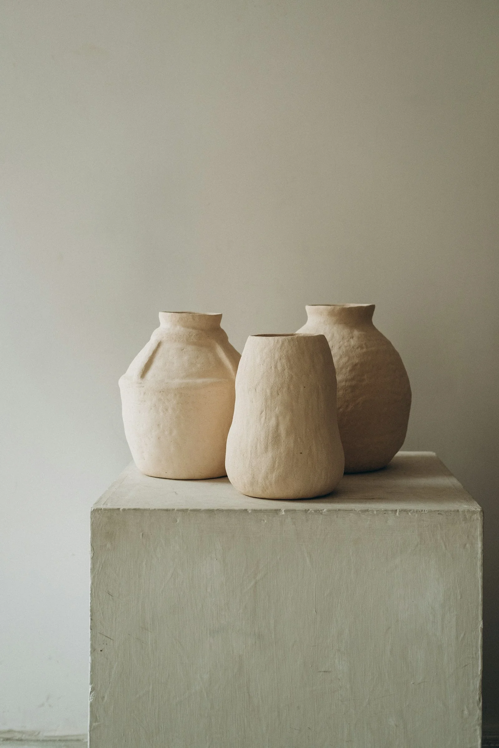 Three ceramic vases with visibly different shapes and finishes