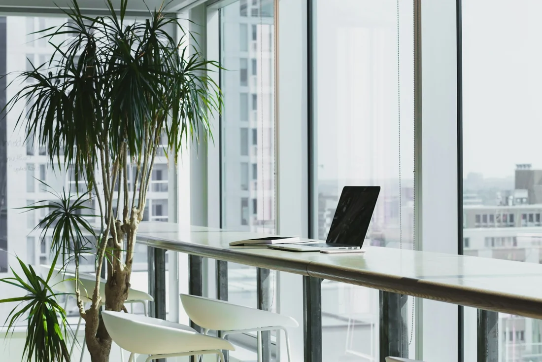 A bright workspace with a desk and large windows